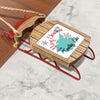 Wooden sled ornament with "Merry Christmas from Timothy Lake" text and snowflakes.