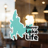 Shaver Lake Life sticker on glass with blurred background.