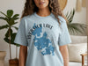 Light blue t-shirt with Webster Lake Massachusetts map graphic and compass rose detail.