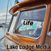 Key West Life decal on a boat window with Lake Lodge Media text below.