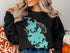 Black sweatshirt with teal Lake Chaubunagungamaug map and "Beautiful Massachusetts" text.