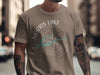T-shirt with Norris Lake, Tennessee compass design and tattooed arms.