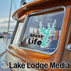 Teal lake outline sticker with "Moss Life" text on a boat window.