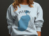 Light blue sweatshirt with Lake Pulaski, Minnesota map and compass graphic.