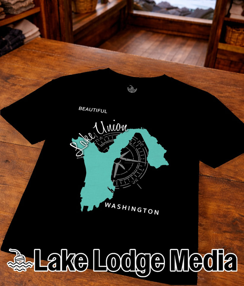 Black t-shirt with teal Lake Union map and compass graphic, "Lake Lodge Media".