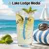 Glass of lime and mint drink, lake graphic, beach background.