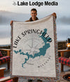 Man holding a woven blanket with Lake Springfield Missouri map and compass design.