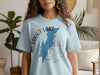 Light blue t-shirt with Trout Lake, New York map and compass graphic.