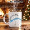 White mug with "Buckeye Lake Ohio" and a compass design, splashing coffee.
