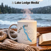 White mug with "Long Lake Maine" and compass rose design on a rainy lake background.