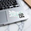 Sticker with Lewis Smith Life text and a teal lake outline on a laptop.