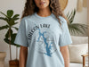 Light blue t-shirt with Falcon Lake Texas map and compass design.