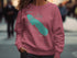 Pink sweatshirt with Onondaga Lake graphic and compass rose.