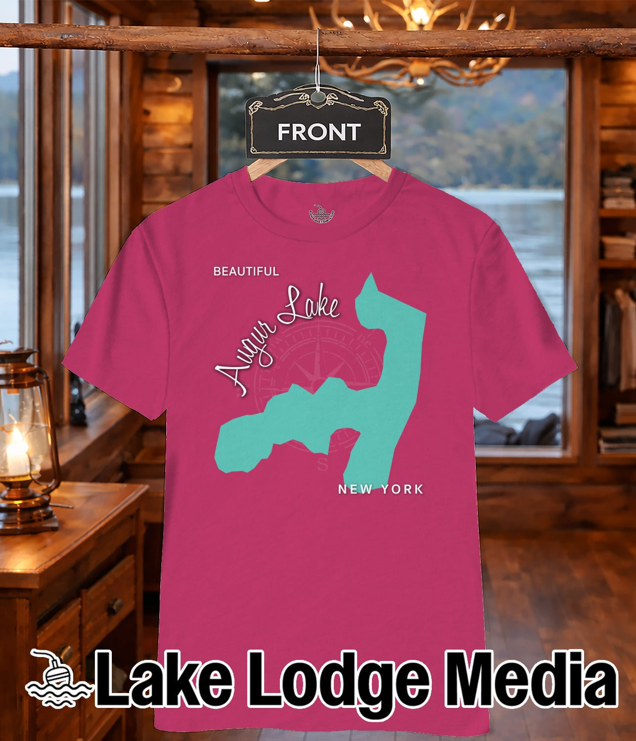 Pink t-shirt with turquoise outline map of Lake Cayuga and "Lake Lodge Media" logo.