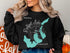 Black sweatshirt with "Beautiful Reelfoot Lake Tennessee" and compass rose graphic.