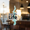 Brookville Life sticker with a turquoise lake outline on glass.