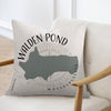 Pillow with Walden Pond Massachusetts map and compass graphic on a chair.