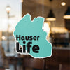 Teal sticker with black text "Hauser Life" on a rippled surface.