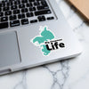 Sticker of Big Chapman Life lake outline with distressed text on a laptop.