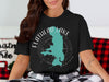 Black t-shirt with Flathead Lake Montana map and compass graphic.