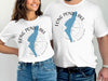 White t-shirts with blue Long Pond Lake shape and compass design.