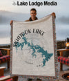 Man holding a woven blanket with a map of Skiatook Lake, Oklahoma design.