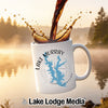 White mug with Lake Murray Oklahoma map and compass design, coffee pouring in.