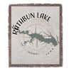 Rathbun Lake Iowa map and compass design on woven blanket with fringed edges.