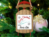 Sled ornament on Christmas tree with "Merry Christmas From Norris Lake" text.