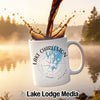 White mug with Lake Charleston Ontario design and splashing coffee.