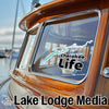 Cherokee Life decal on a wooden boat window, with Lake Lodge Media logo below.