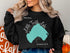 Black sweatshirt with "Beautiful Little Turtle Lake" and Minnesota map graphic.