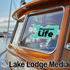 Manasquan Life logo sticker on a boat window with "Lake Lodge Media" text.