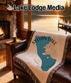 Throw blanket with Sylvan Lake, South Dakota outline and compass rose design.