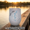White insulated wine tumbler with Lay Lake Alabama map and compass design sitting on a wooden dock.