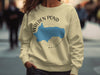 Cream sweatshirt with Walden Pond, Massachusetts map and compass graphic.