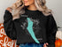 Black sweatshirt with "Beautiful Lake Willoughby Vermont" and compass rose graphic.