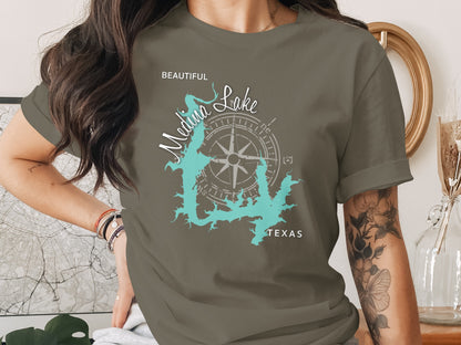 Olive t-shirt with Medina Lake Texas map and compass graphic.
