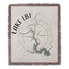 Woven blanket with map of Lake LBJ, Texas, and compass rose design.