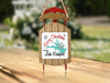 Wooden sled ornament with "Merry Christmas from Lake Rampart" text.