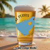 Glass of beer with "Lake Perris" graphic on a beach with palm trees.