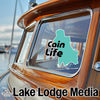 Teal shape with "Cain Life" text overlaying a boat's wooden window.