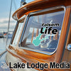 Folsom Life logo on a boat window and Lake Lodge Media text with graphic.