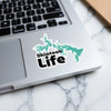Skiatook Life sticker on a laptop keyboard and marble surface.