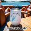 A white travel tumbler with a compass graphic and the text Great Sacandaga Lake New York sits on a boat table.
