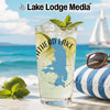 Glass with beverage, lime, mint, and "Eagle Lake" map, on beach background.