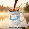 White mug with "Lake Crescent" and Washington state map design, coffee splashing.