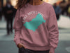 Pink crewneck sweatshirt with Lake Mascuppic New Hampshire map and compass design.