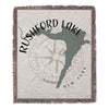 Woven blanket with Rushford Lake shape and compass rose design.