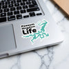 Possum Kingdom Life sticker on a laptop keyboard with teal lake outline.